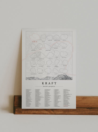 A cream color, customized rock climbing ticklist poster for the Kraft rock climbing location at the Red Rocks in Las Vegas, Nevada. The design has an overlay of crag topography, nature landscapes, and traced boulders, the person's name, and a list of bouldering problems at the bottom. Displayed as wall art in a living room.